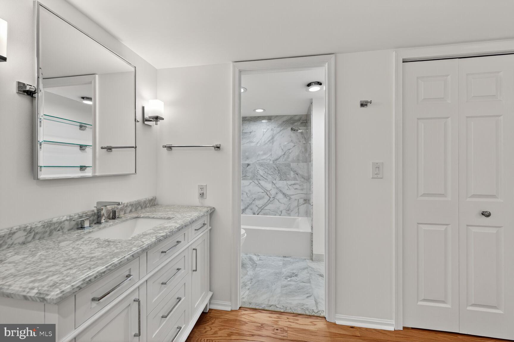 2100 Langston Boulevard, Unit 339 Arlington, VA 22201 - Photo 8 of 21 a bathroom with a granite countertop sink and a mirror