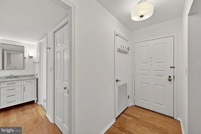a view of a refrigerator in kitchen and white cabinets