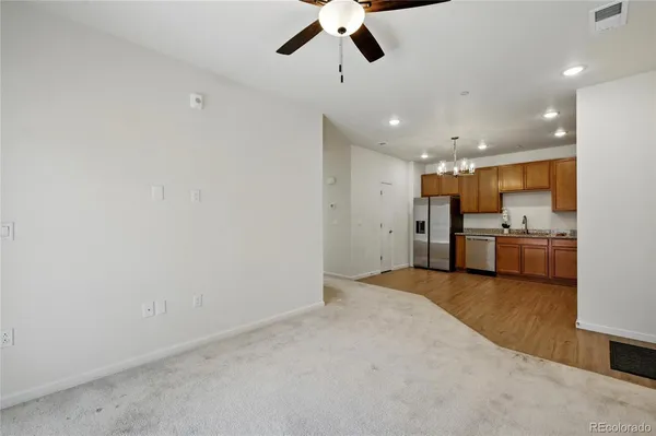 a view of a kitchen with a sink and stainless steel appliances