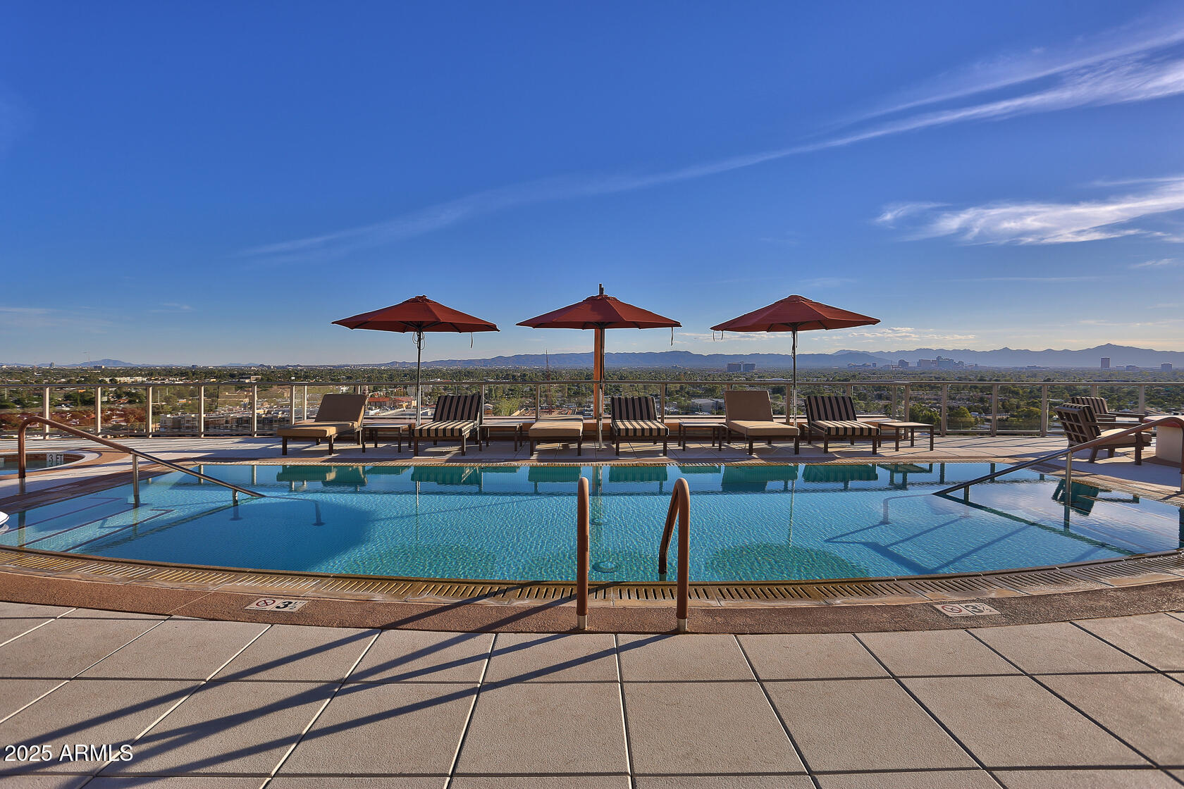 2211 East Camelback Road, Unit 506 Phoenix, AZ 85016 - Photo 2 of 10 a outdoor space with furniture and umbrella