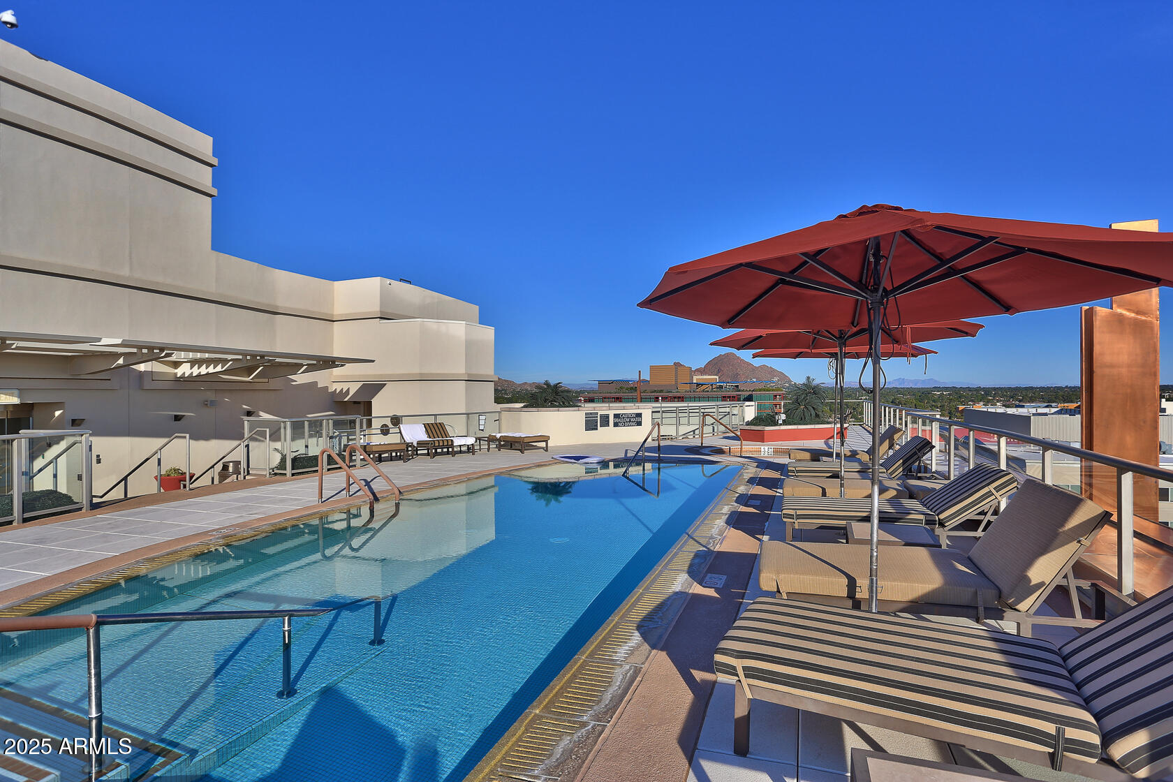2211 East Camelback Road, Unit 506 Phoenix, AZ 85016 - Photo 3 of 10 a view of a balcony with chairs and wooden floor