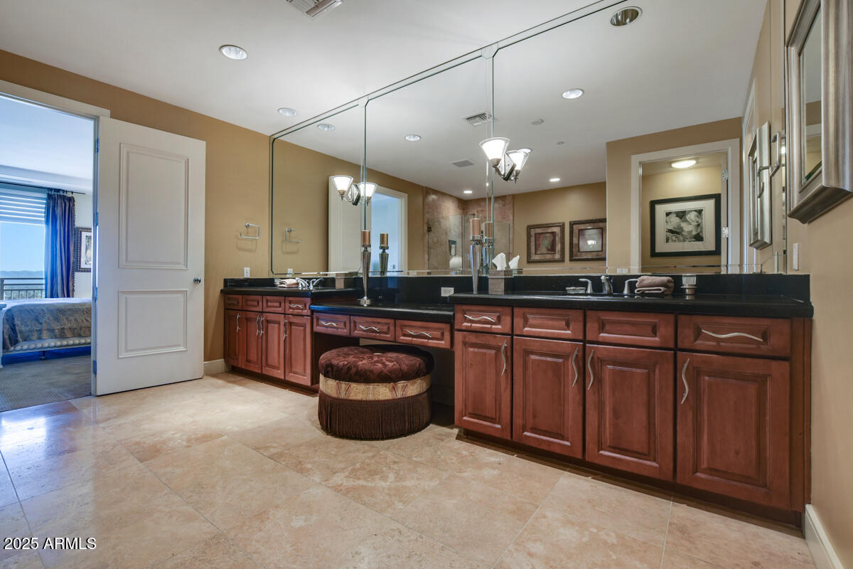 2211 East Camelback Road, Unit 506 Phoenix, AZ 85016 - Photo 4 of 10 a large kitchen with stainless steel appliances granite countertop a stove a sink and a refrigerator