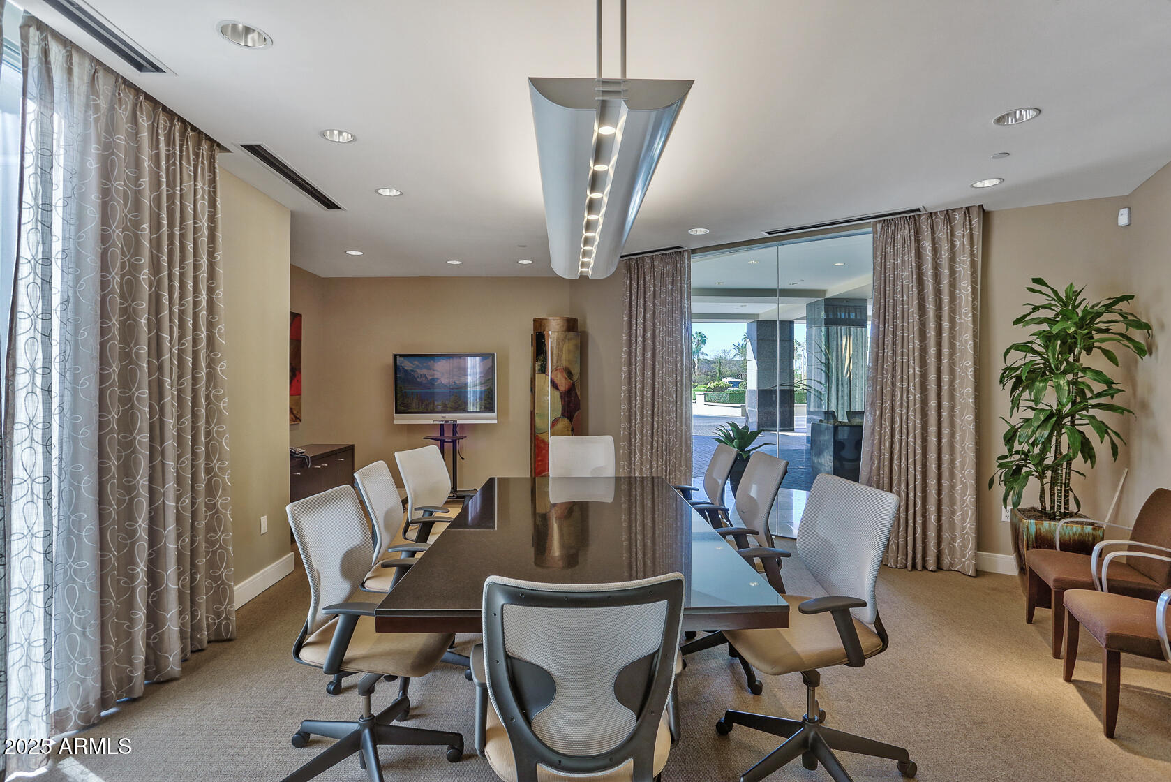 2211 East Camelback Road, Unit 506 Phoenix, AZ 85016 - Photo 9 of 10 a view of a dining room with furniture and a chandelier