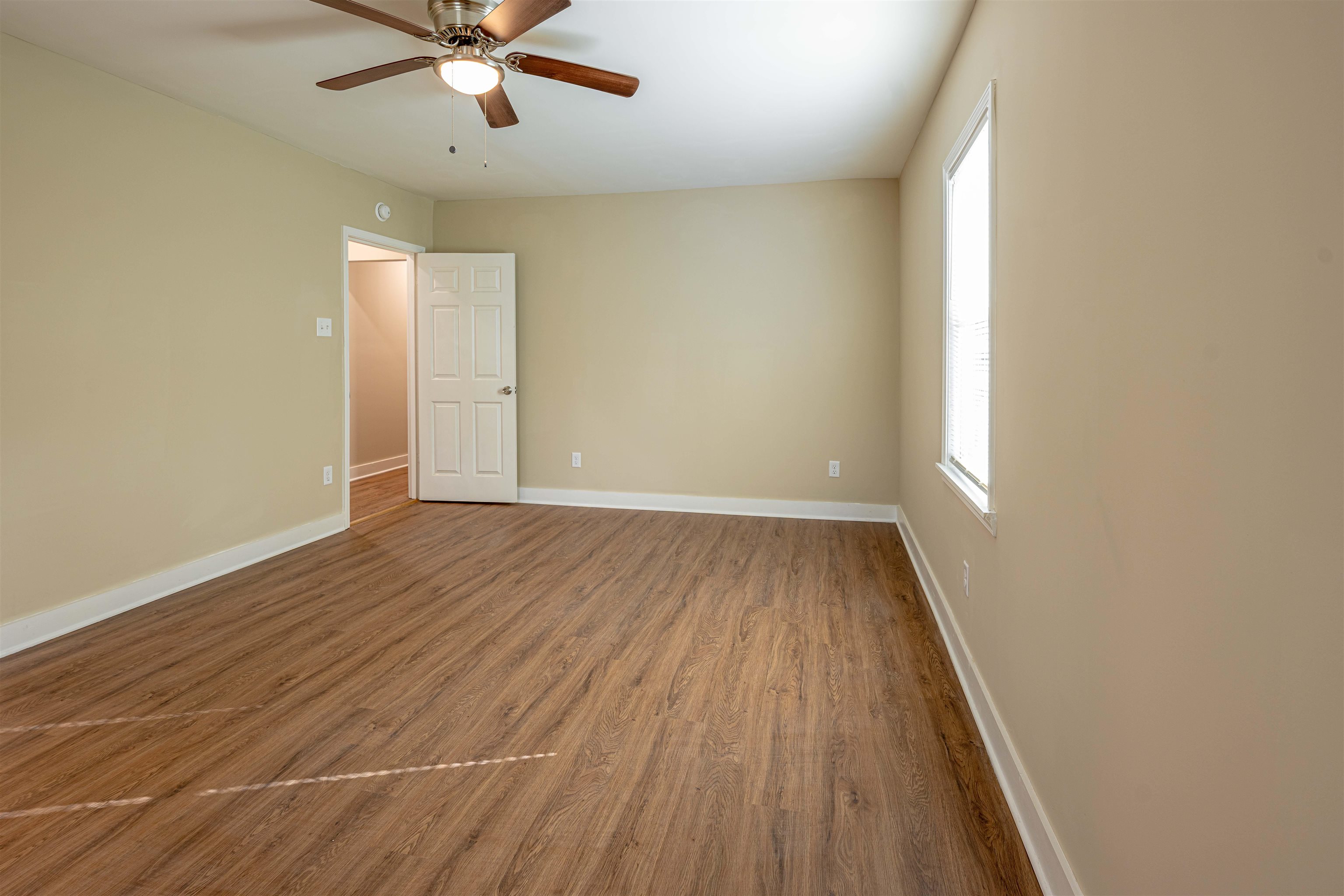 721 South Graham Street Memphis, TN 38111 - Photo 15 of 28 an empty room with wooden floor fan and windows