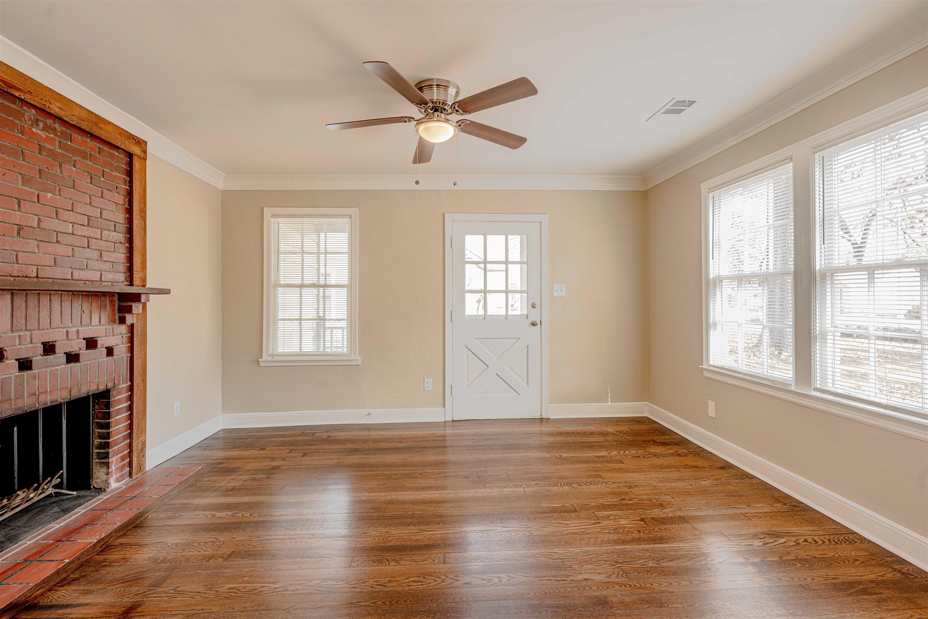 721 South Graham Street Memphis, TN 38111 - Photo 6 of 28 an empty room with wooden floor fan and windows