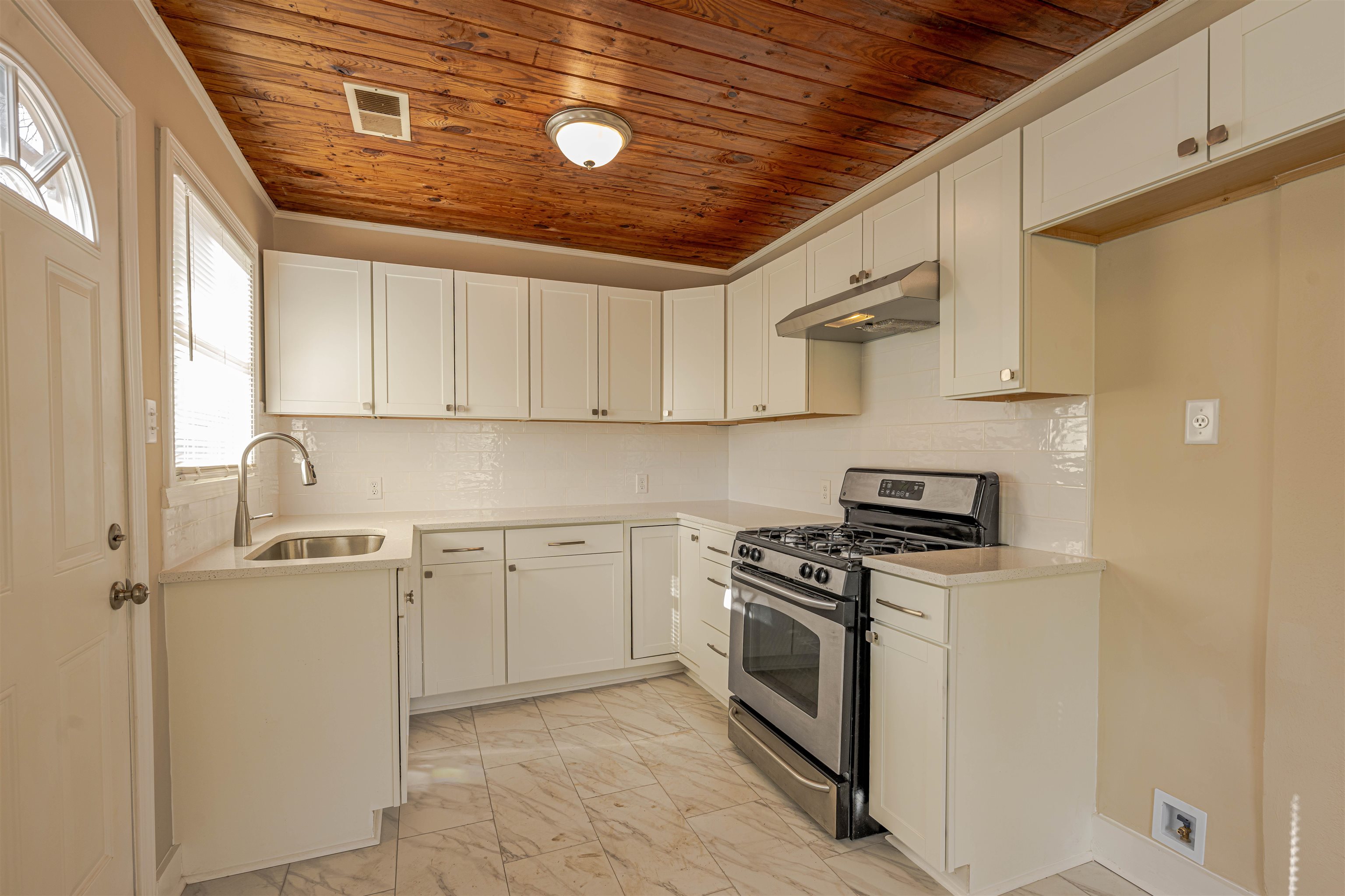 721 South Graham Street Memphis, TN 38111 - Photo 8 of 28 a kitchen with stainless steel appliances granite countertop a stove sink and cabinets