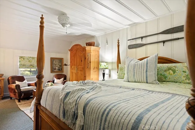 a spacious bedroom with a bed and a window