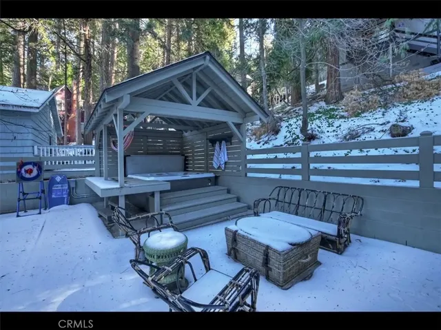a view of a chairs and table in the back yard of the house