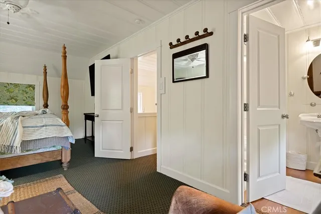 a view of a bedroom with furniture and window