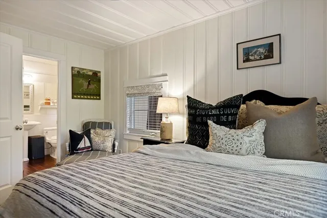 a bedroom with a bed and a painting on the wall