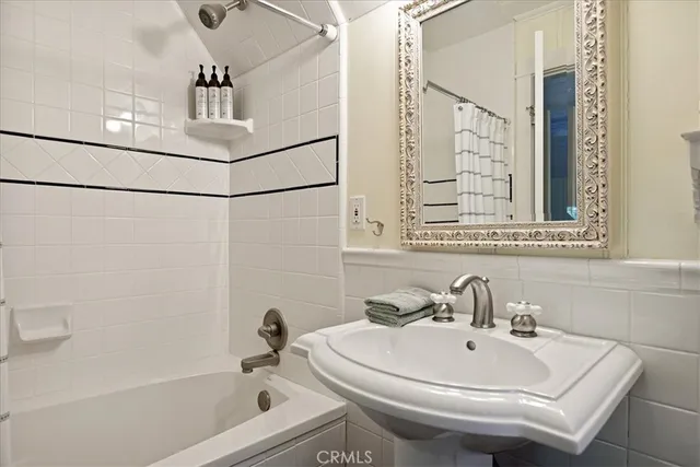 a bathroom with a sink a mirror and shower