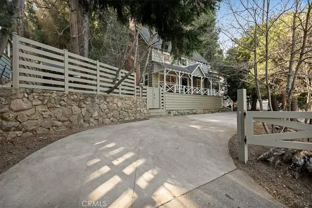 a view of a yard with wooden fence