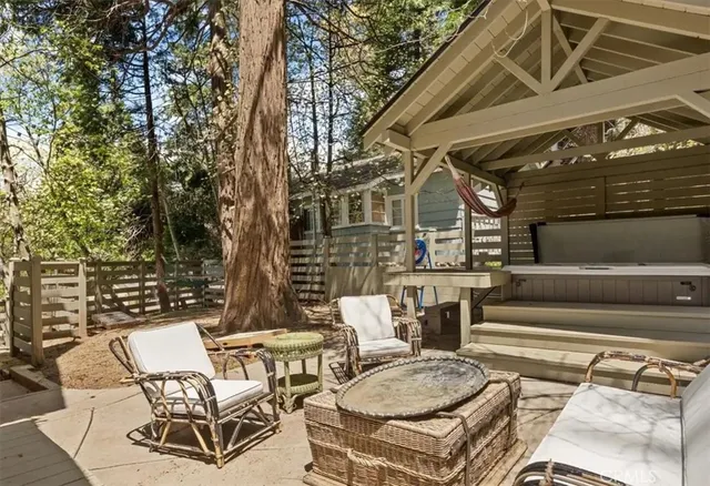 a view of a patio with table and chairs with wooden floor and fence