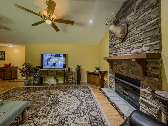 a living room with furniture flat screen tv and a fireplace