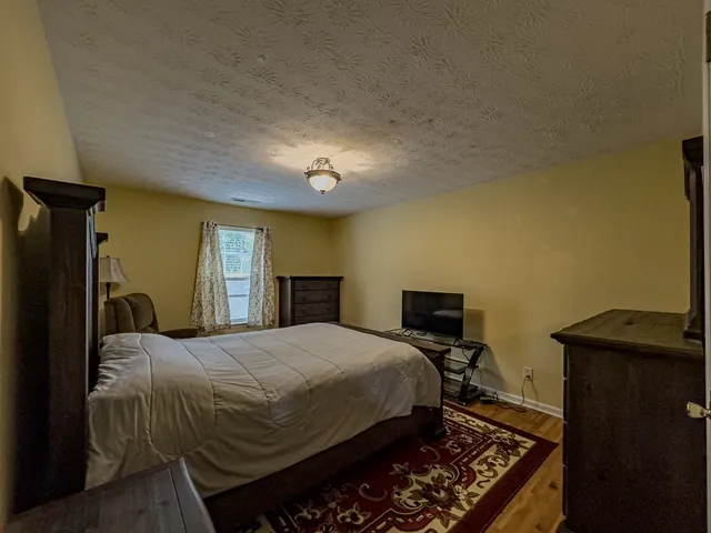 a bedroom with a bed and a tv