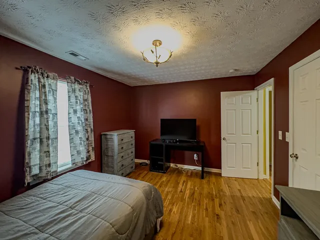 a kitchen with stainless steel appliances granite countertop a refrigerator a sink a stove and a refrigerator