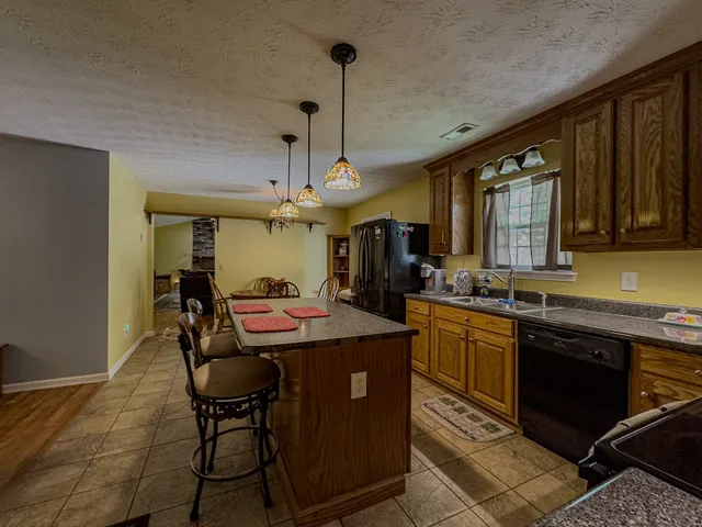 a roof deck with table and chairs and potted plants