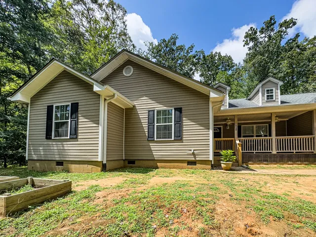 a view of a house with a wooden deck