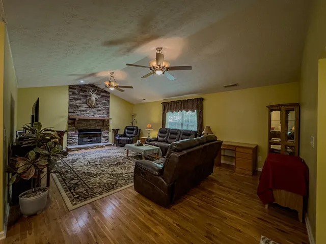 a living room with furniture and a fireplace