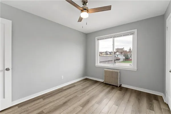 wooden floor in an empty room with a window