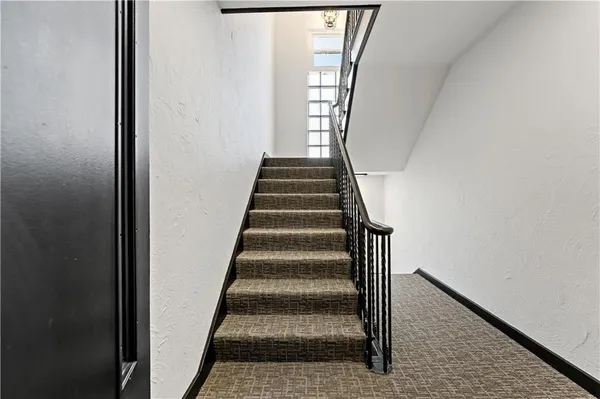 a view of a hallway with a wooden door