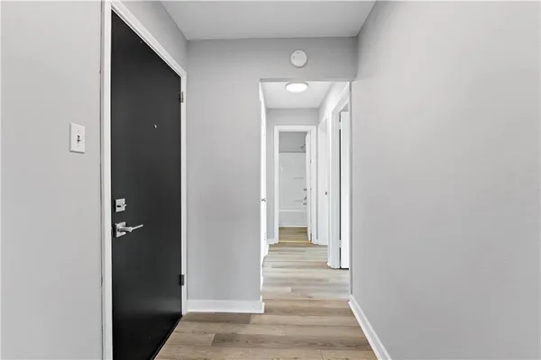 a view of a hallway with wooden floor and staircase