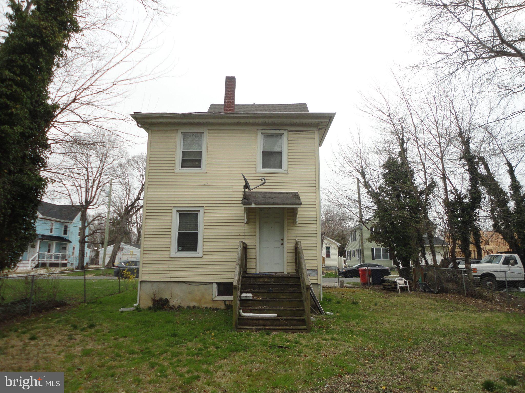 46 Ellis Street Bridgeton, NJ 08302 - Photo 2 of 8 a front view of a house with a garden