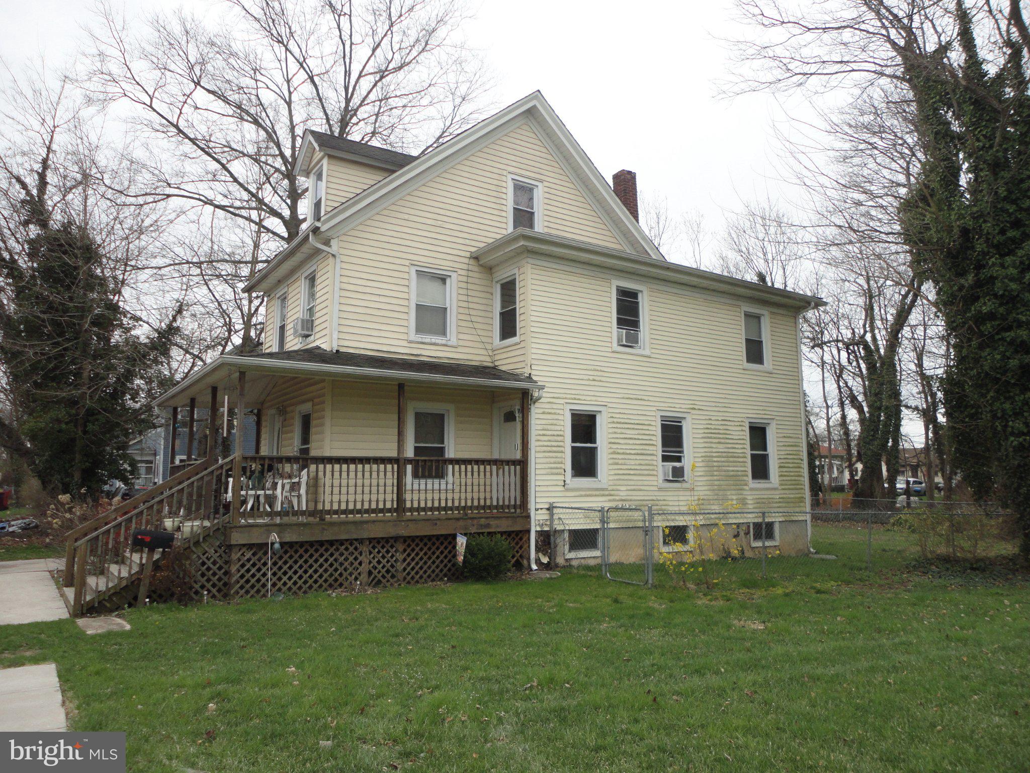 46 Ellis Street Bridgeton, NJ 08302 - Photo 4 of 8 a white house that has a tree in front of it