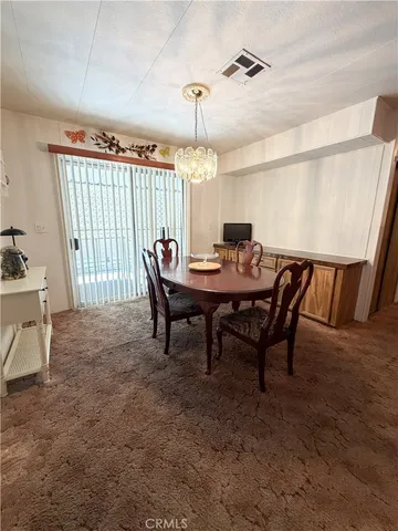 a view of a dining room with furniture and window