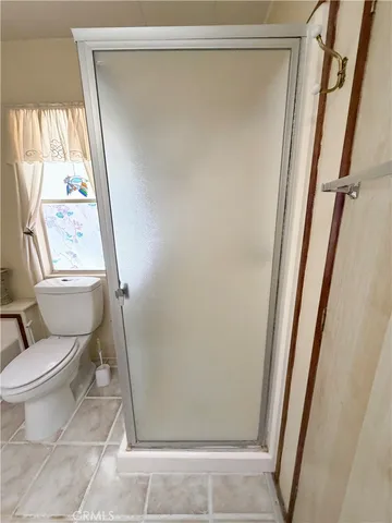 a bathroom with a toilet and a shower