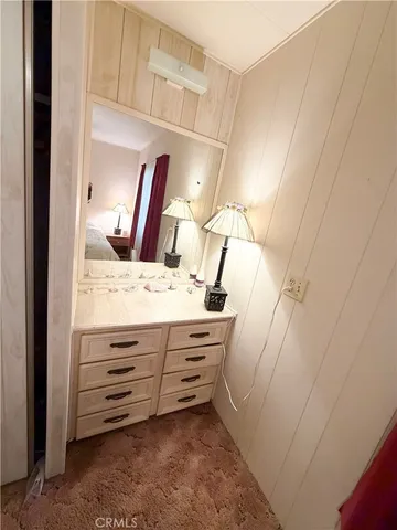 a view of bathroom with a sink and mirror