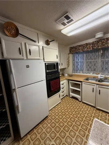 a kitchen with a refrigerator and a stove