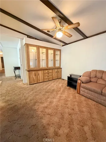 a view of a livingroom with furniture and staircase