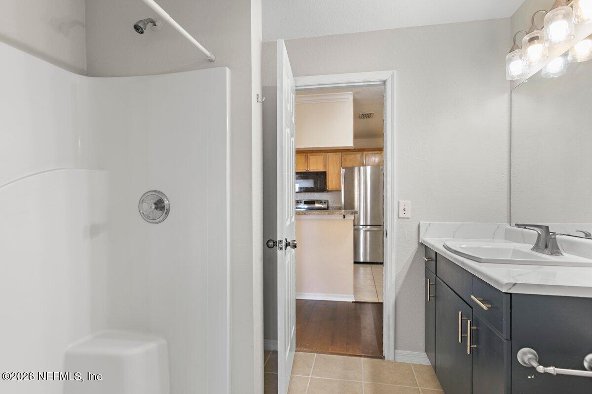 10961 Burnt Mill Road, Unit 333 Jacksonville, FL 32256 - Photo 11 of 21 a bathroom with a sink and mirror