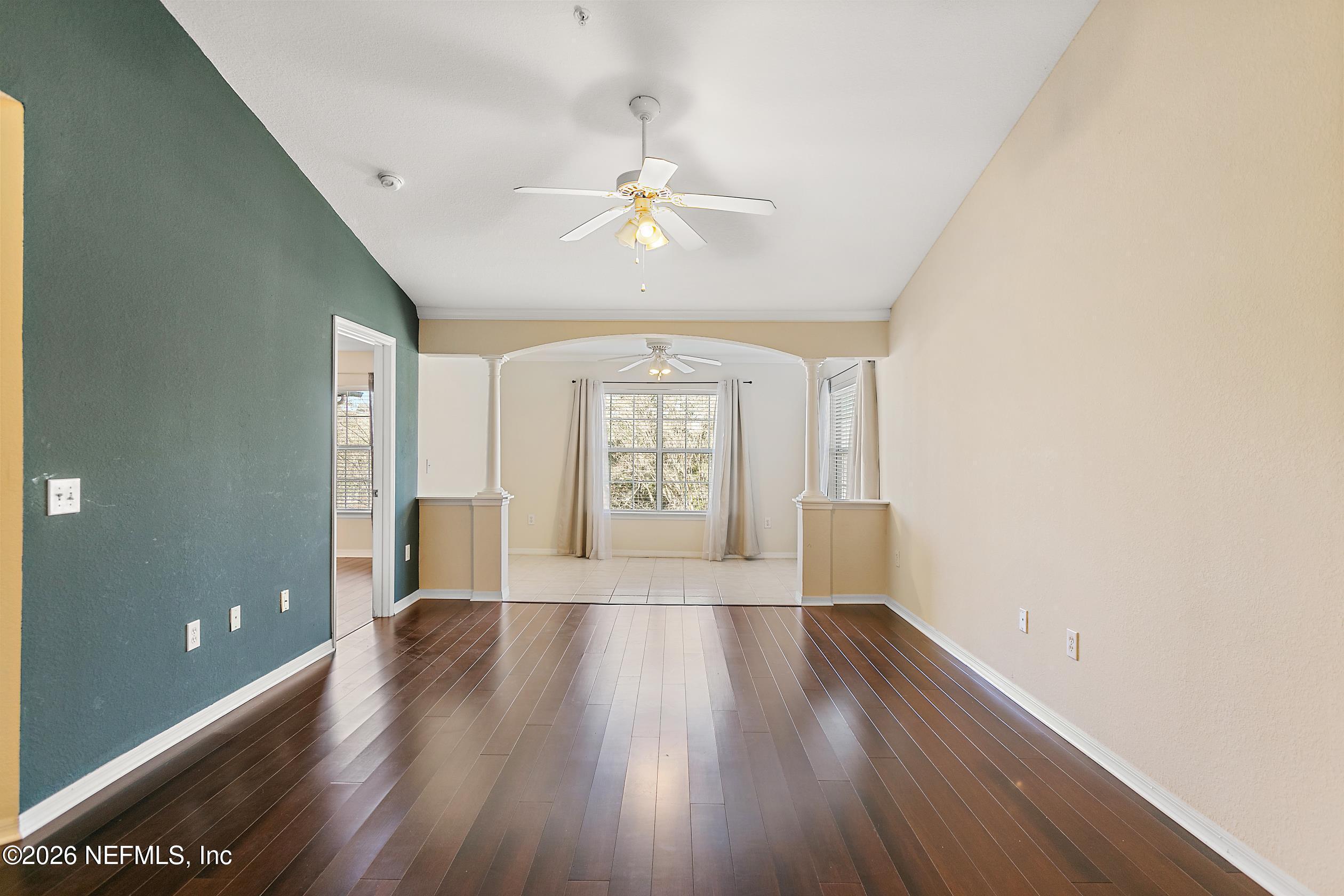 10961 Burnt Mill Road, Unit 333 Jacksonville, FL 32256 - Photo 12 of 21 wooden floor in an empty room with a window