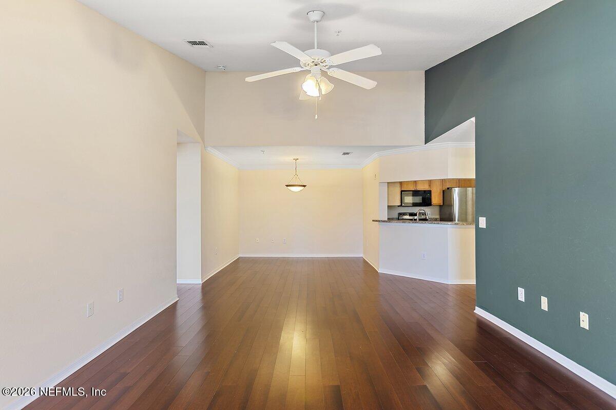 10961 Burnt Mill Road, Unit 333 Jacksonville, FL 32256 - Photo 13 of 21 a view of a kitchen with wooden floor and a ceiling fan