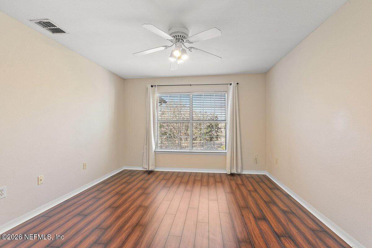 10961 Burnt Mill Road, Unit 333 Jacksonville, FL 32256 - Photo 14 of 21 wooden floor in an empty room with a window