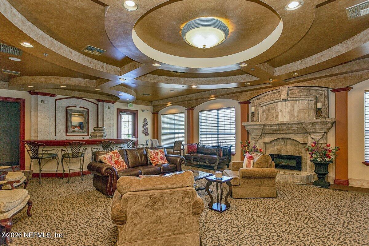 10961 Burnt Mill Road, Unit 333 Jacksonville, FL 32256 - Photo 17 of 21 a living room with furniture a fireplace and a table