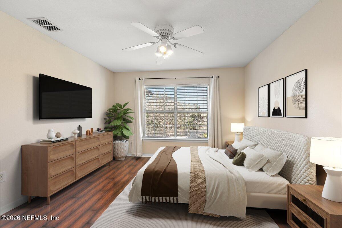 10961 Burnt Mill Road, Unit 333 Jacksonville, FL 32256 - Photo 7 of 21 a spacious bedroom with a bed and a flat screen tv
