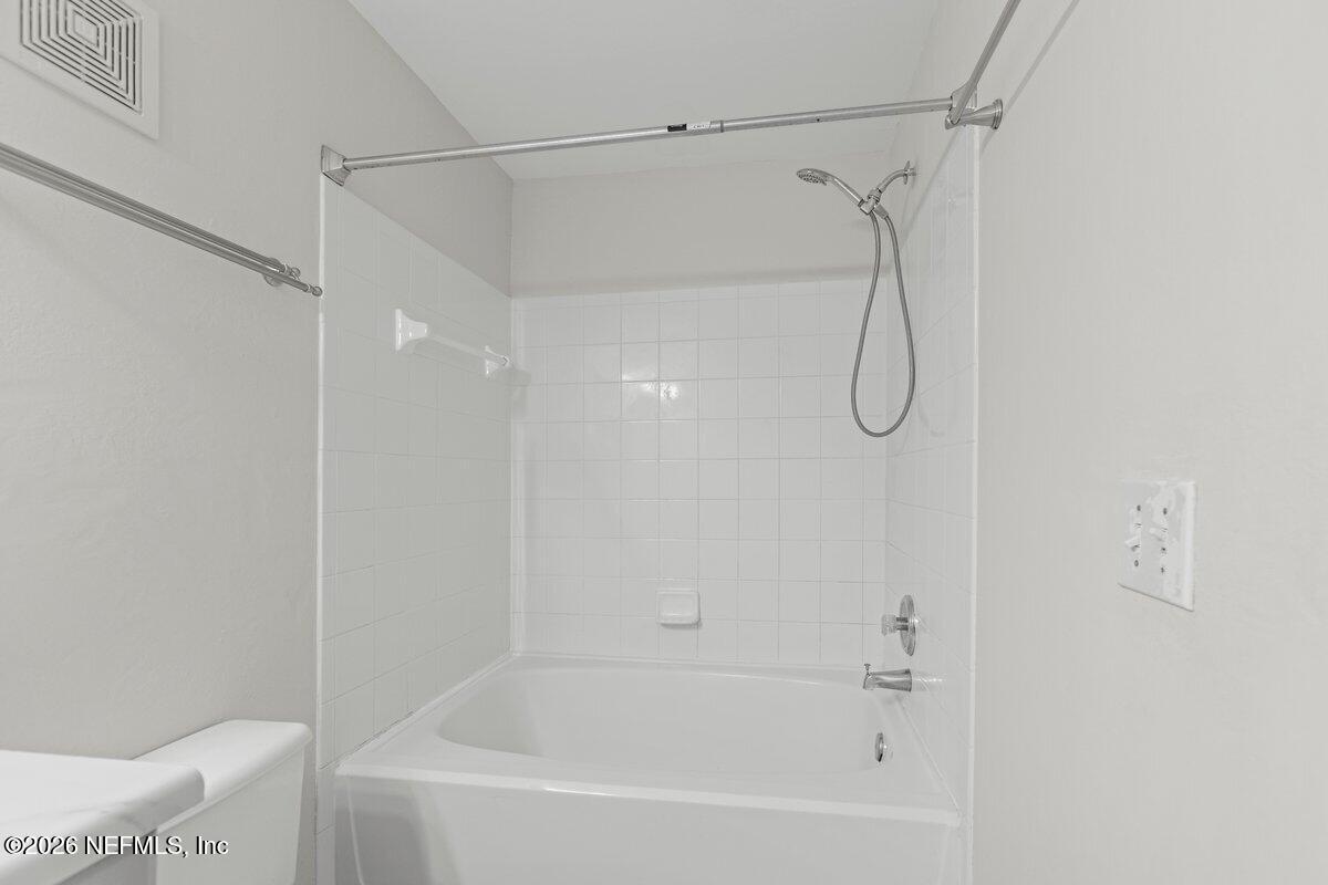 10961 Burnt Mill Road, Unit 333 Jacksonville, FL 32256 - Photo 9 of 21 a bathroom with a bath tub with a shower