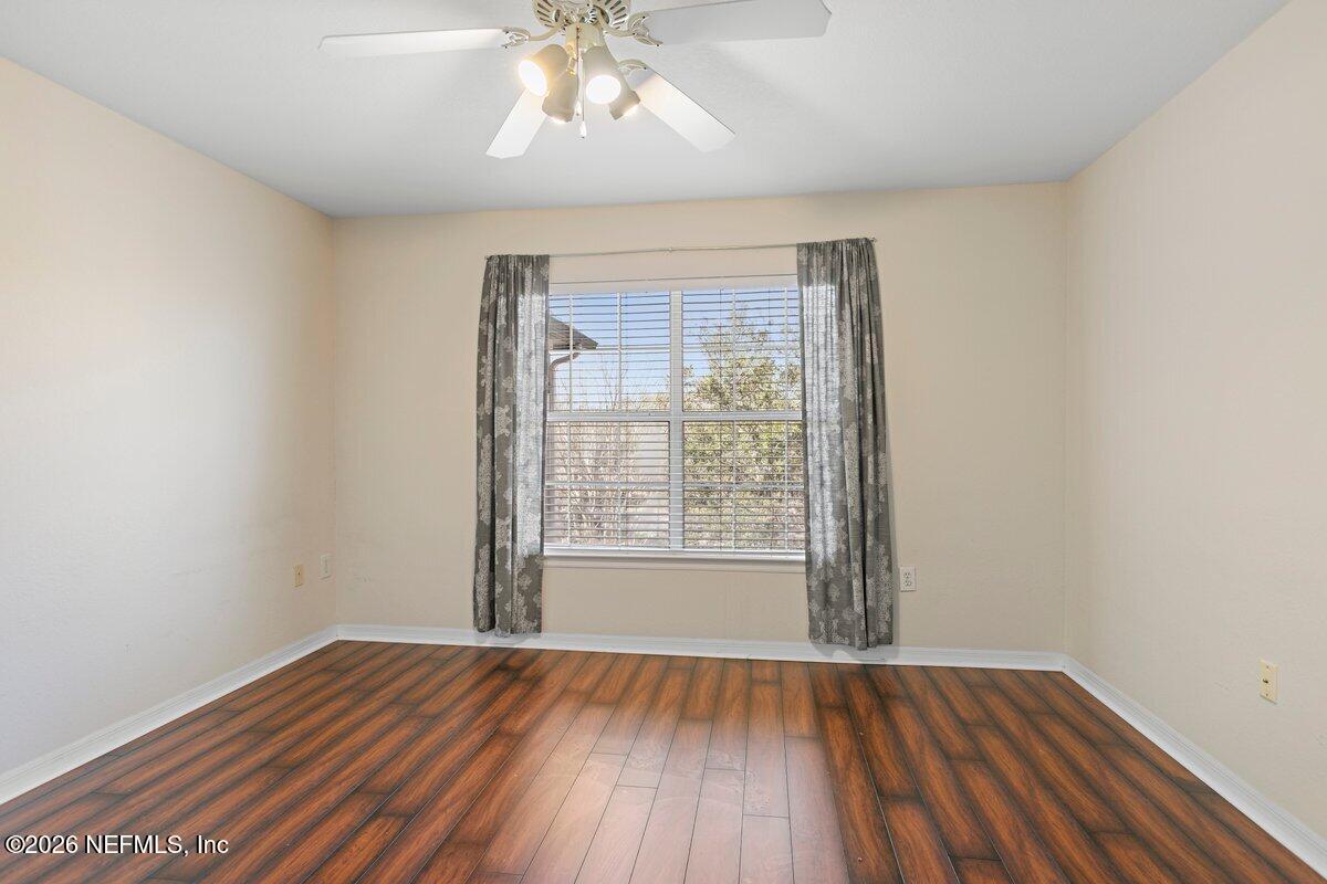 10961 Burnt Mill Road, Unit 333 Jacksonville, FL 32256 - Photo 10 of 21 an empty room with wooden floor and windows