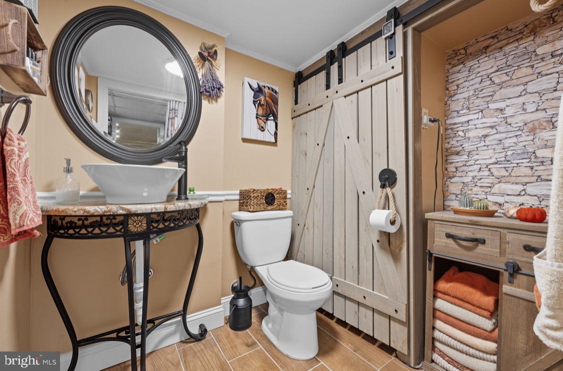 914 Thornton Road Upper Chichester, PA 19061 - Photo 15 of 29 a bathroom with a toilet a sink and a mirror