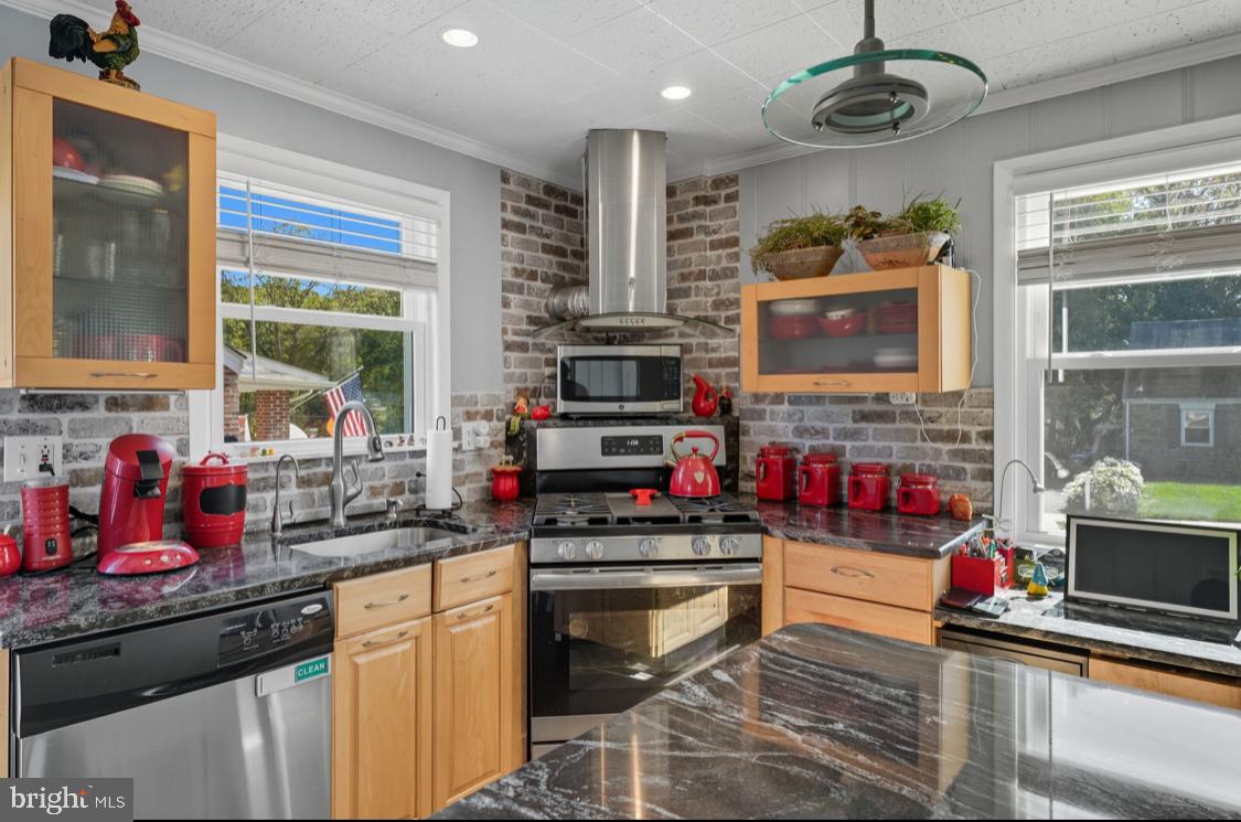 914 Thornton Road Upper Chichester, PA 19061 - Photo 3 of 29 a kitchen with stainless steel appliances kitchen island granite countertop a stove and cabinets