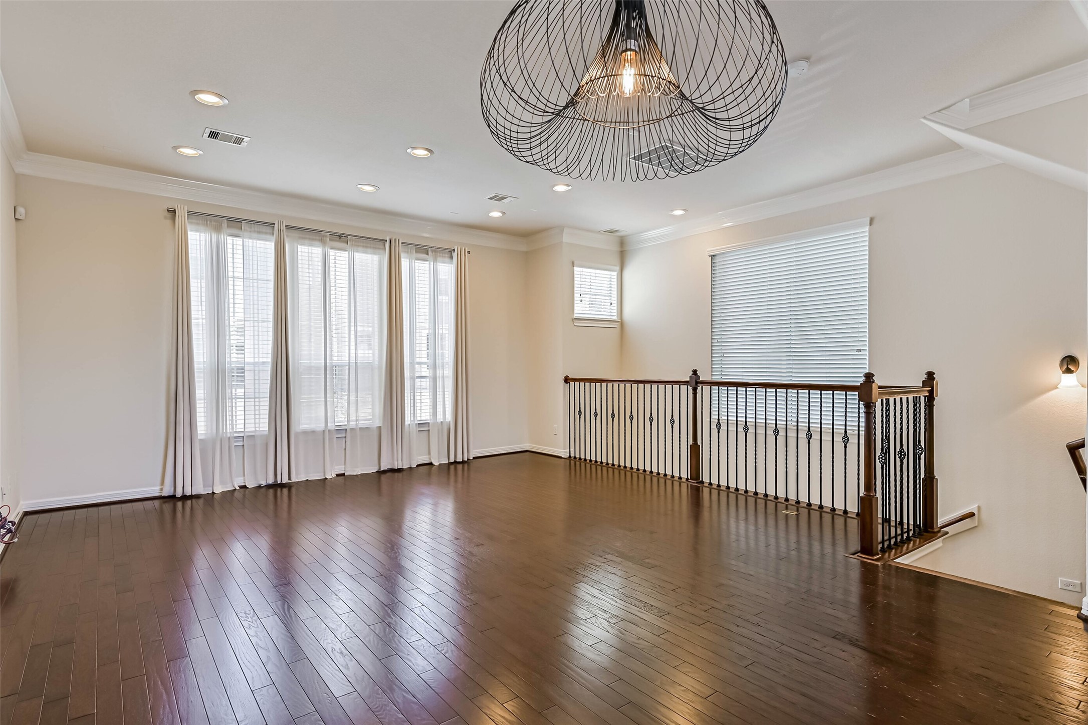 3208 Clearview Circle Houston, TX 77025 - Photo 10 of 30 Tall windows fill the main living area with natural light, while hardwood floors add warmth and an airy, inviting feel.