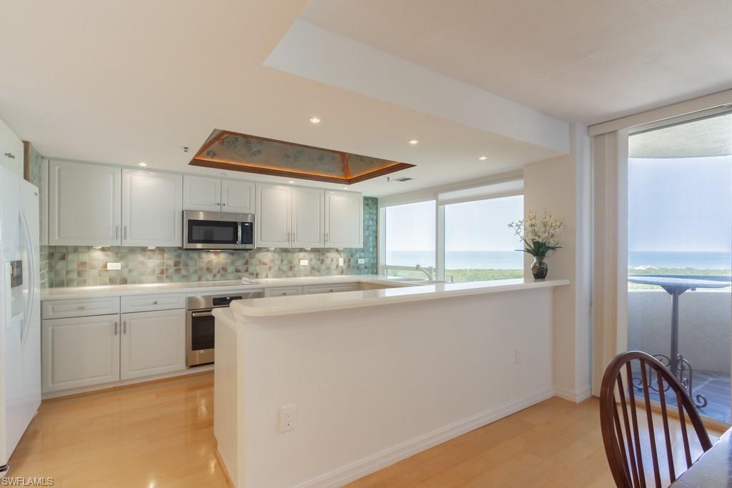 6825 Grenadier Boulevard, Unit 1505 Naples, FL 34108 - Photo 12 of 35 a kitchen with stainless steel appliances granite countertop a sink and stove
