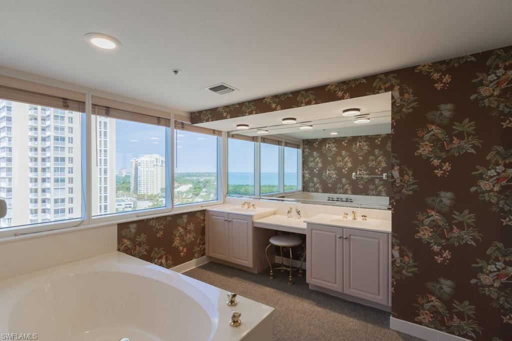 6825 Grenadier Boulevard, Unit 1505 Naples, FL 34108 - Photo 18 of 35 a large white kitchen with a large window