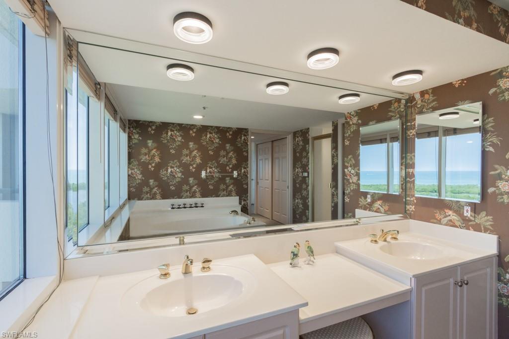 6825 Grenadier Boulevard, Unit 1505 Naples, FL 34108 - Photo 20 of 35 a bathroom with a sink and a mirror