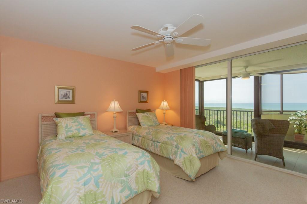 6825 Grenadier Boulevard, Unit 1505 Naples, FL 34108 - Photo 21 of 35 a bedroom with two beds and a large window