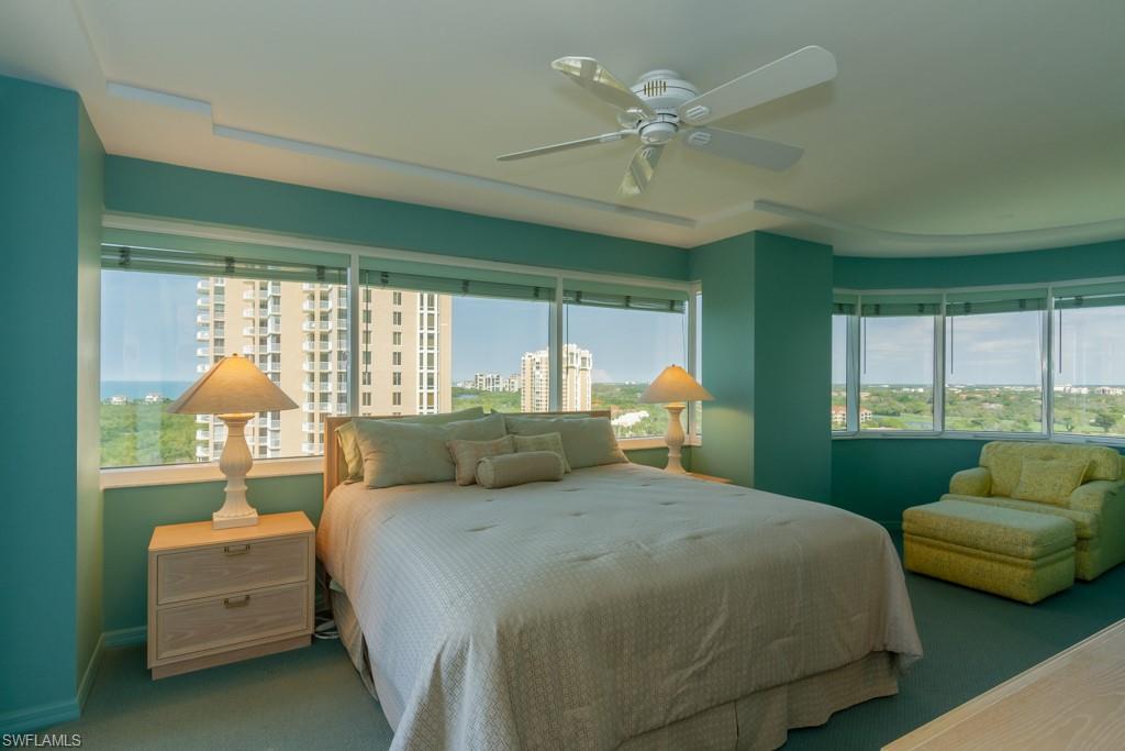 6825 Grenadier Boulevard, Unit 1505 Naples, FL 34108 - Photo 25 of 35 a bedroom with a bed and a large window