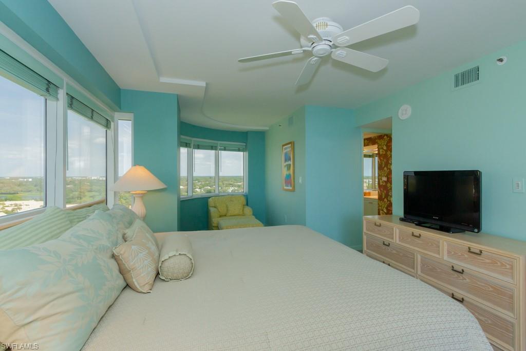6825 Grenadier Boulevard, Unit 1505 Naples, FL 34108 - Photo 26 of 35 a bedroom with a bed and a flat screen tv